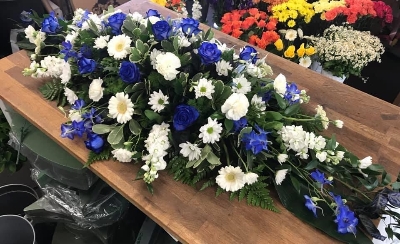 Blue and white casket spray