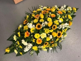 Yellow and white casket spray